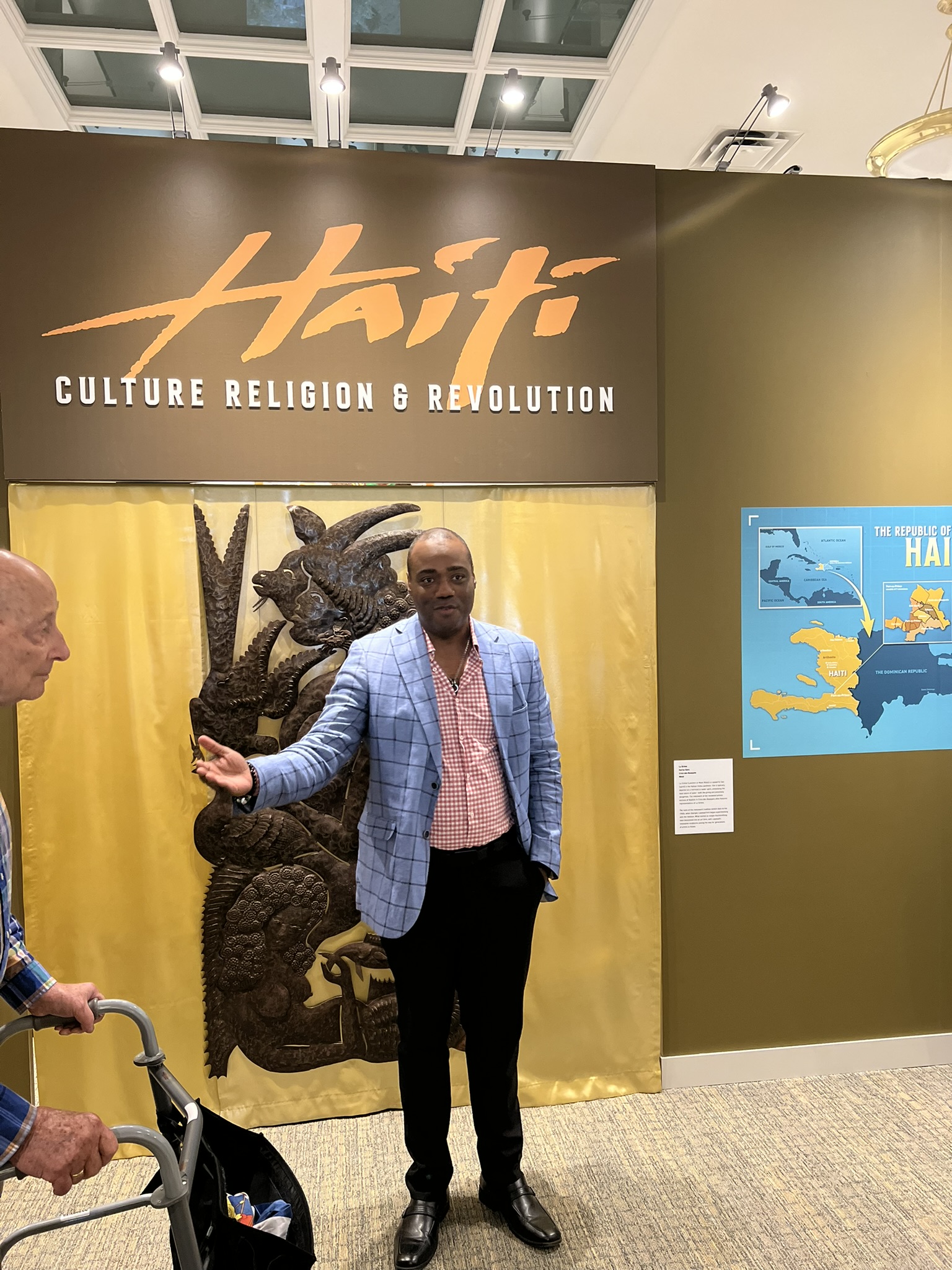 Erlantz Hyppolite, Executive Director, Fonkoze in front of the Haiti exhibition