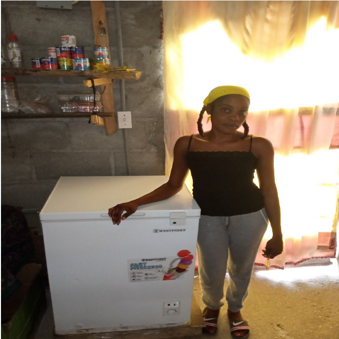 Woman with freezer in Haiti